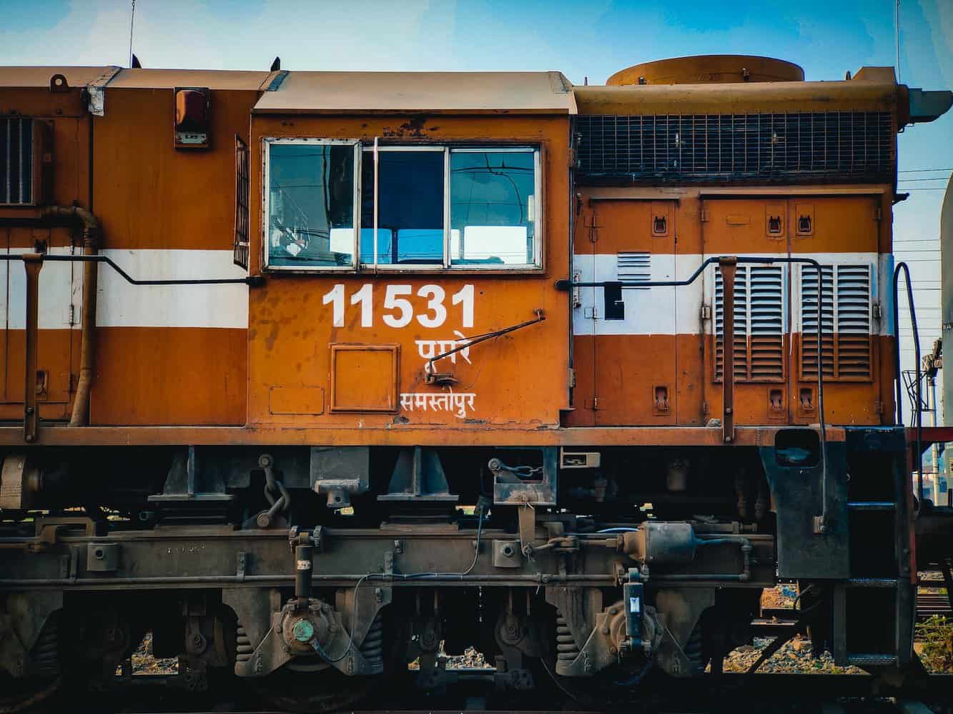 orange train on rail tracks