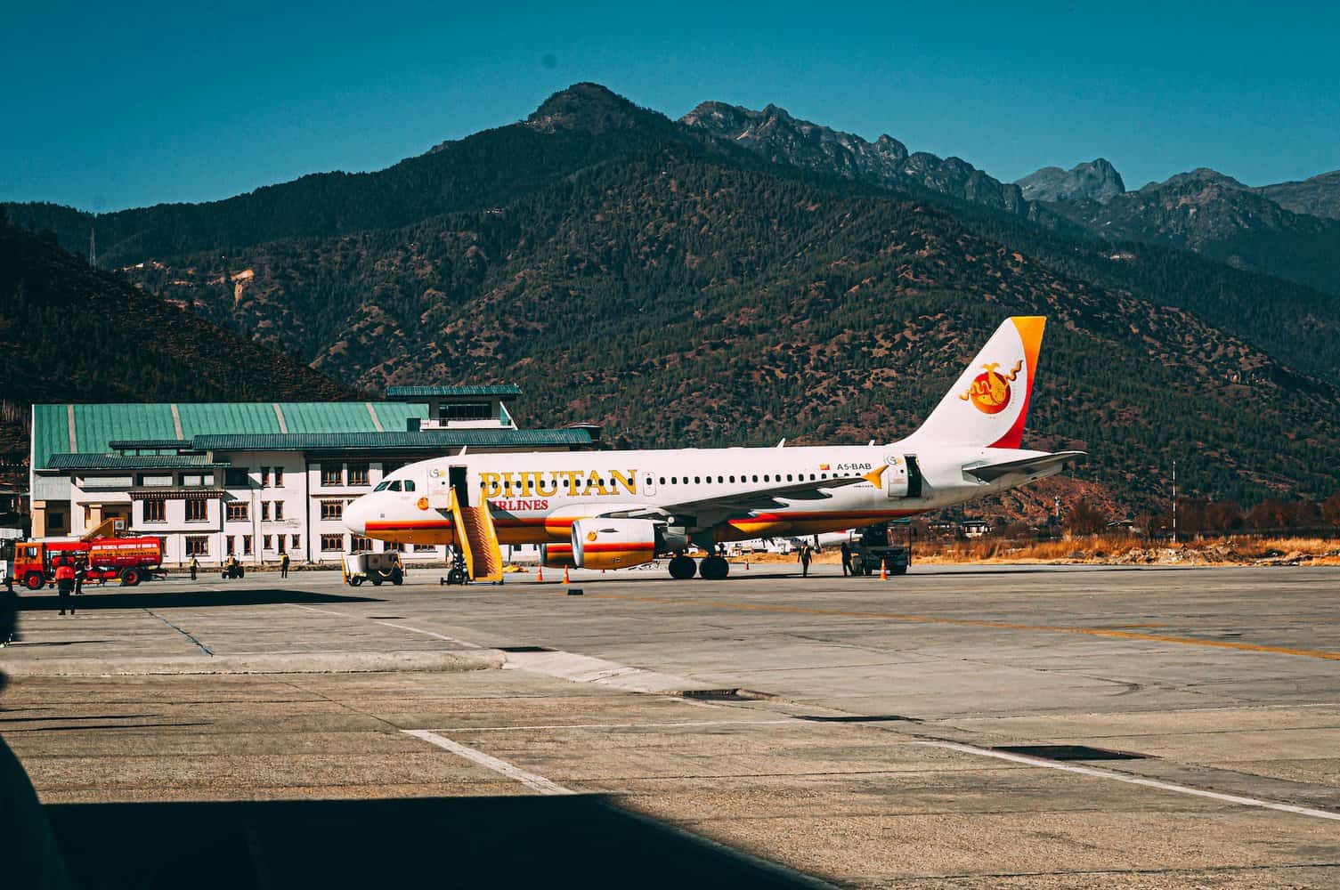 passenger plane on tarmac. Bhutan Airlines. they only allowed tourism in the 70s, so regained thier tradtional culture. could this be why bhutan is the happiest country