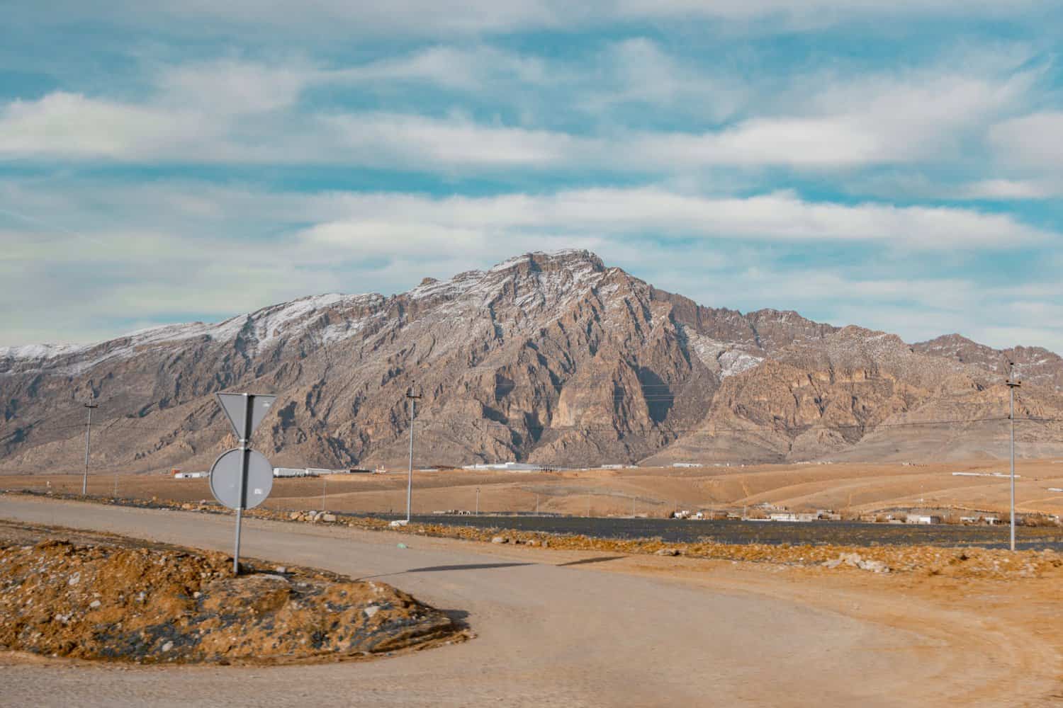 clouds over mountain and road near