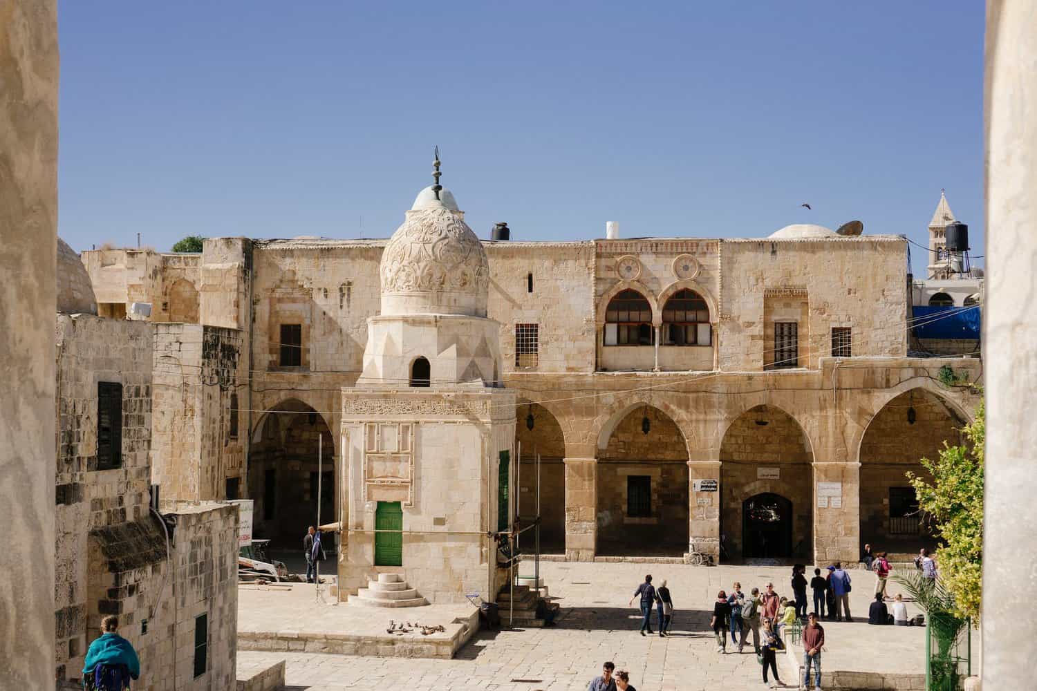 people strolling at the ancient building of the biblical sites