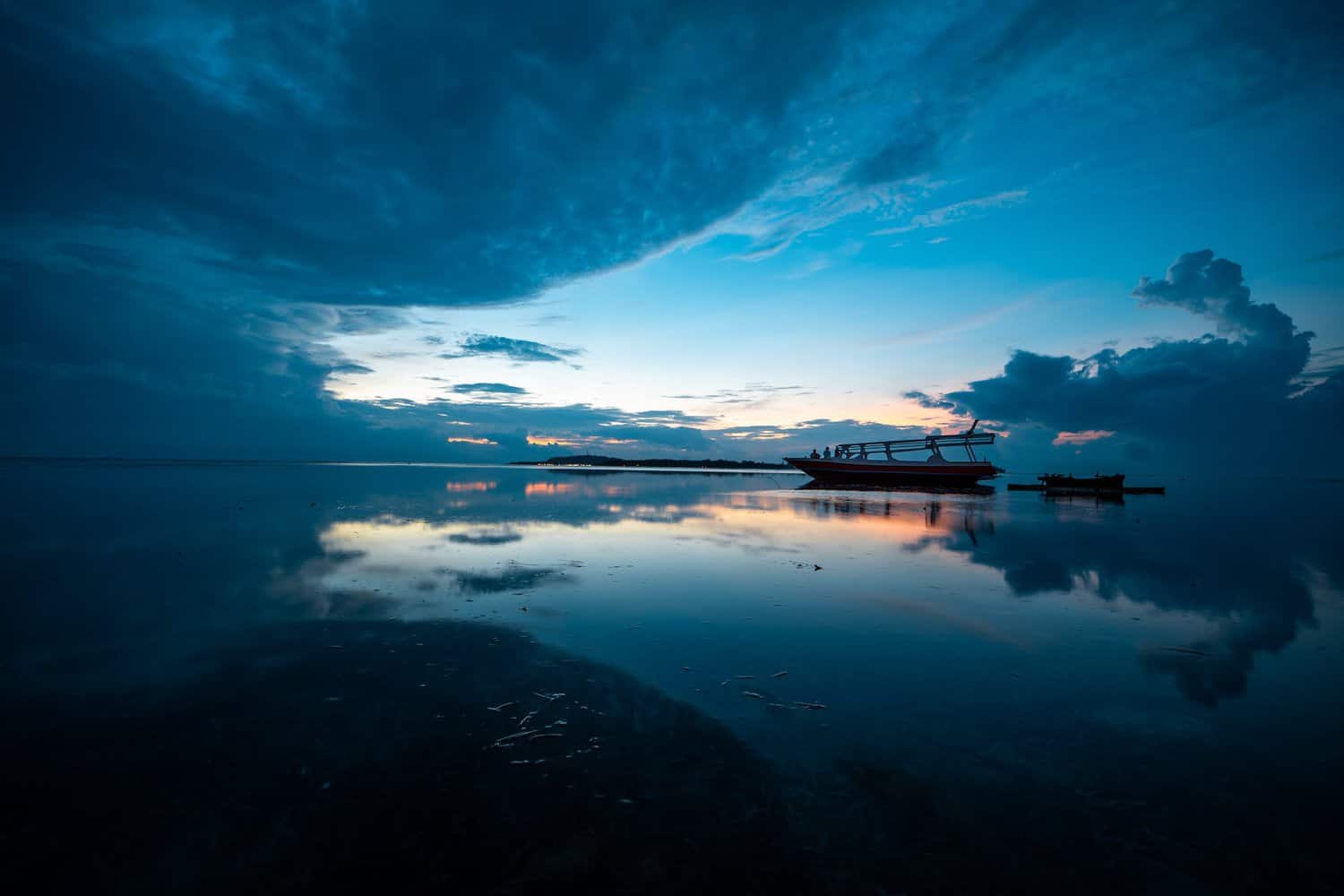 silhouette of boat on shore