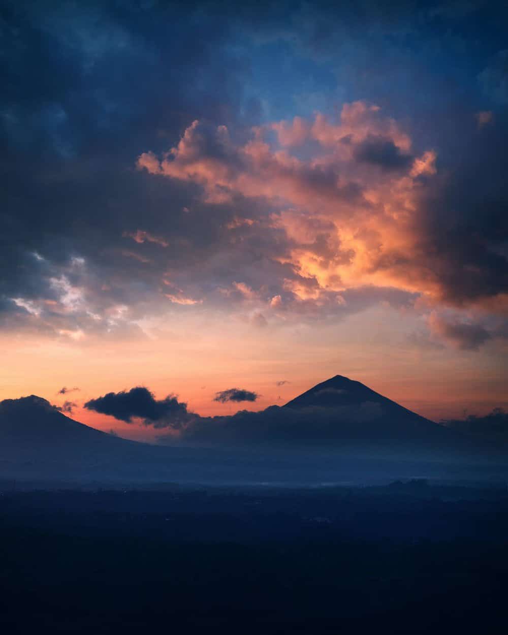silhouette of mountain under cloudy sky during sunset 3-week bali itinerary