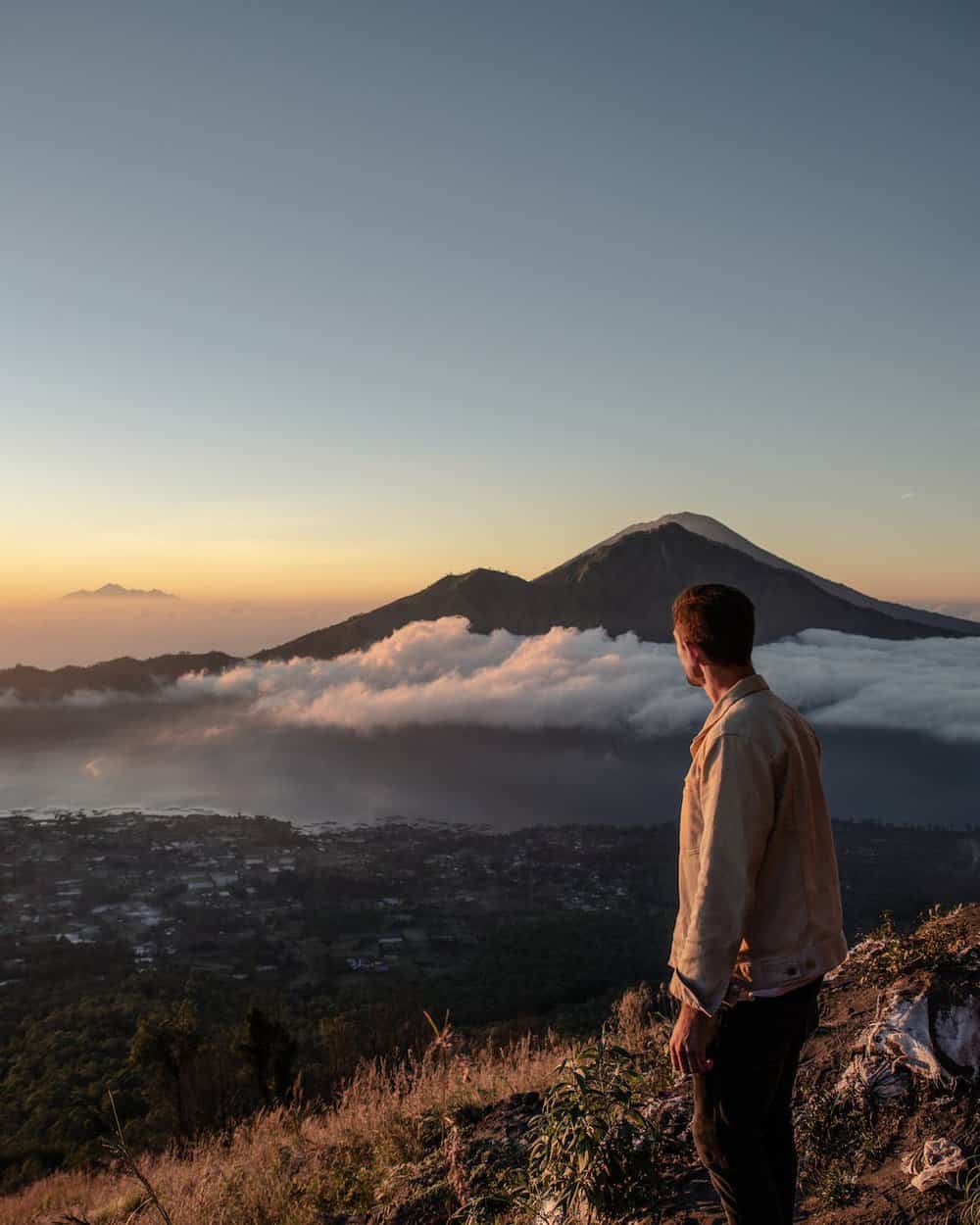 a man standing on the mountain summit