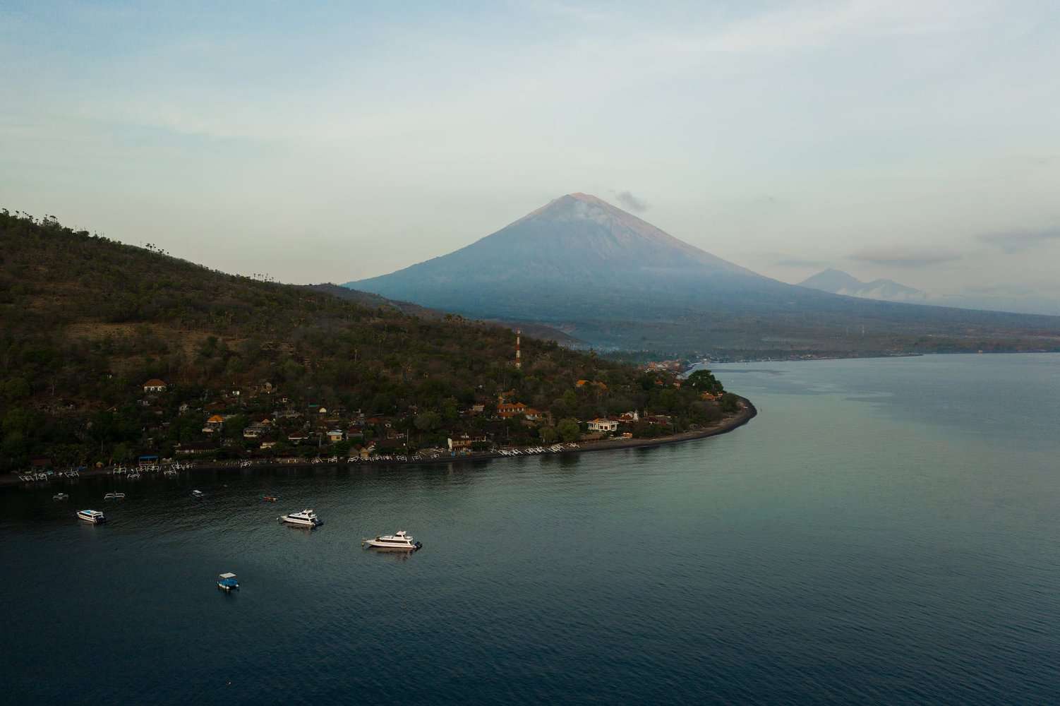 an aerial shot of a shore with a view of a volcano 3-week bali itinerary