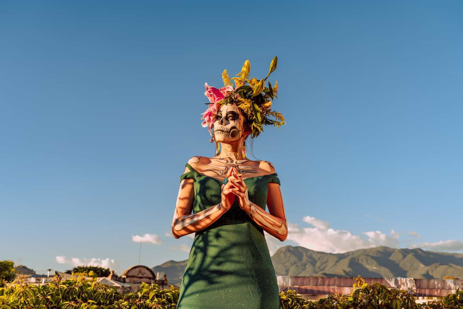 portrait of woman wearing traditional dia de los muertos makeup