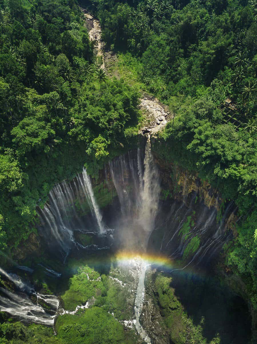 aerial view of waterfalls with rainbow tumpak sewu east java itinerary malang