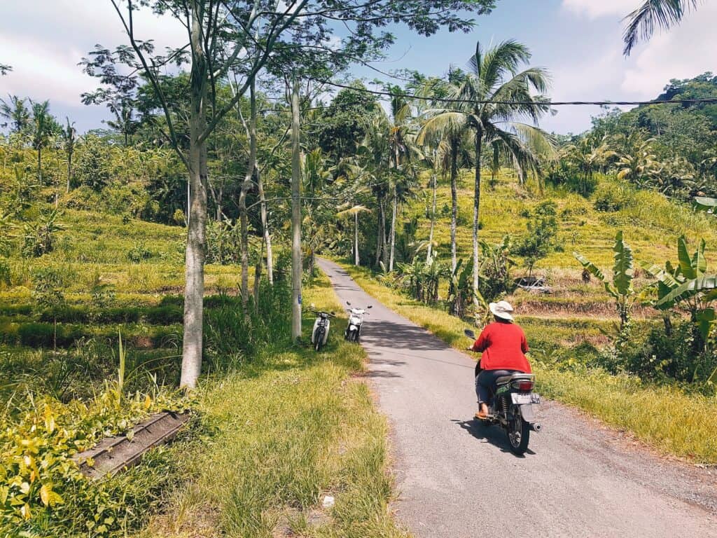 person riding on motorcycle during daytime. bali vs thailand