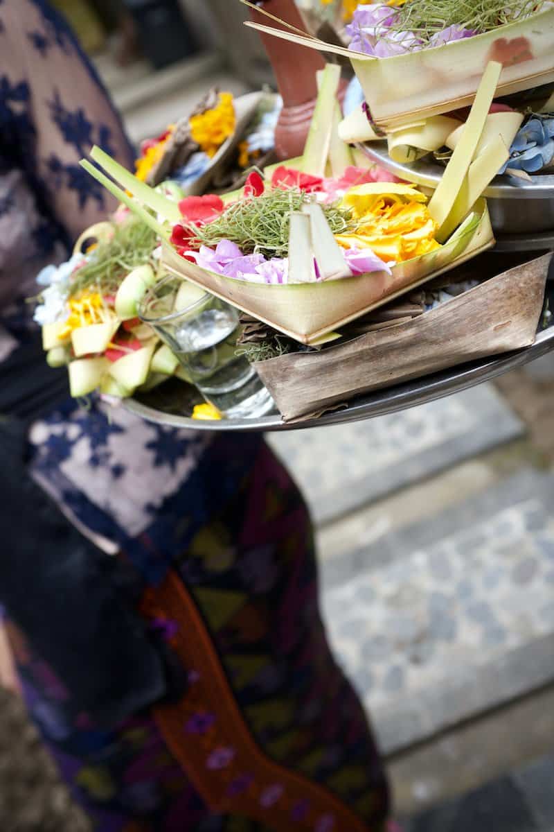 shallow focus photo of person holding tray local culture in indonesia