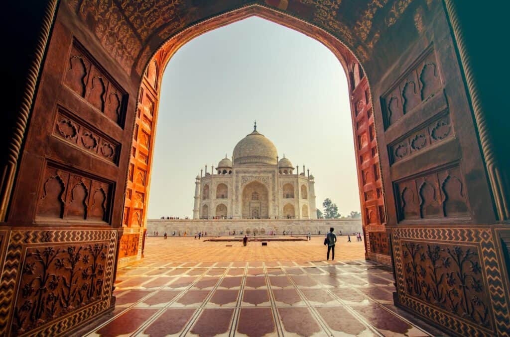impressive building and photo of grand architecture at sunset people near TAj Mahal So, can solo travellers safely explore India? 